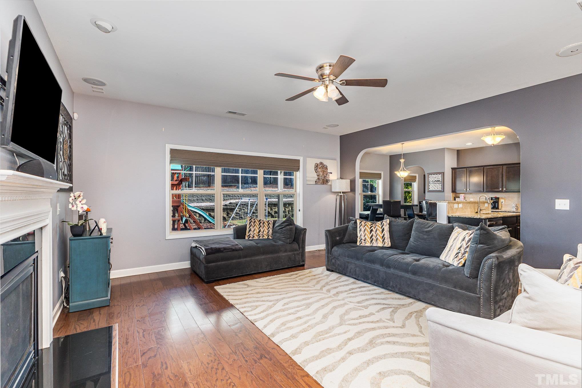 1604 Hauser Lake Road Knightdale, NC 27545 - Photo 10 of 32 a living room with furniture a flat screen tv and a fireplace