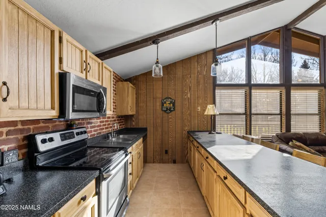 a kitchen with stainless steel appliances granite countertop a stove and a sink