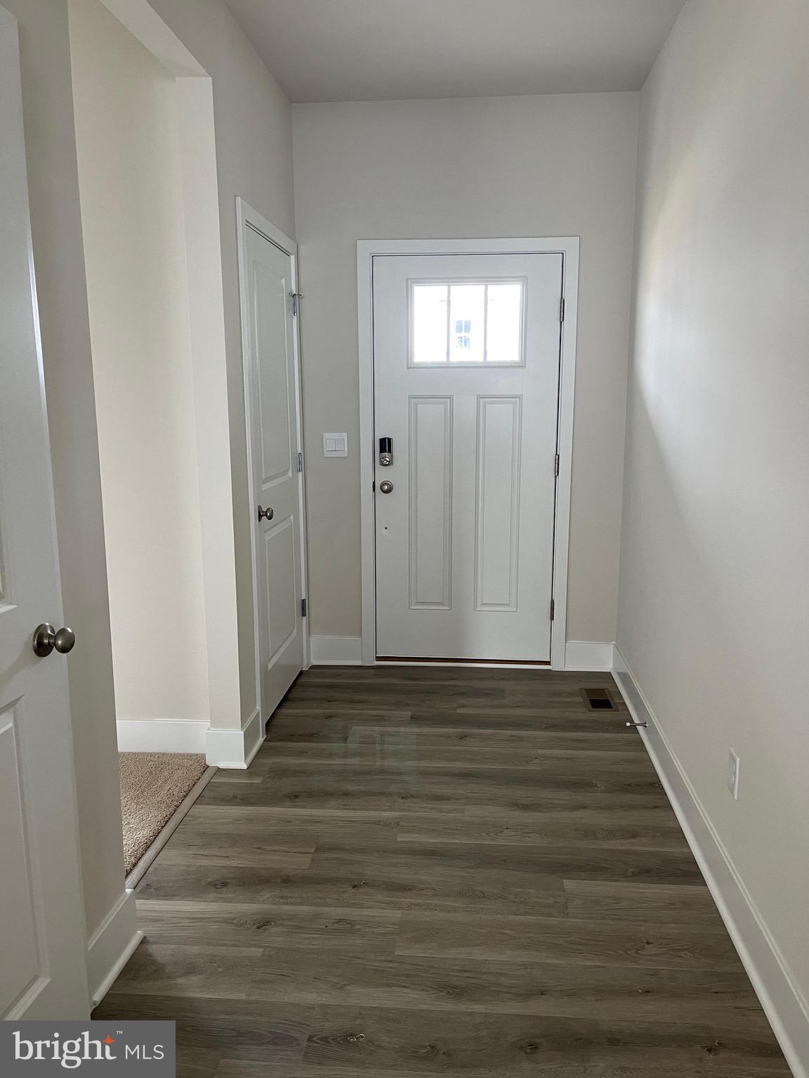 117 Manasquan Way Winchester, VA 22602 - Photo 7 of 34 a view of an empty room with wooden floor and closet
