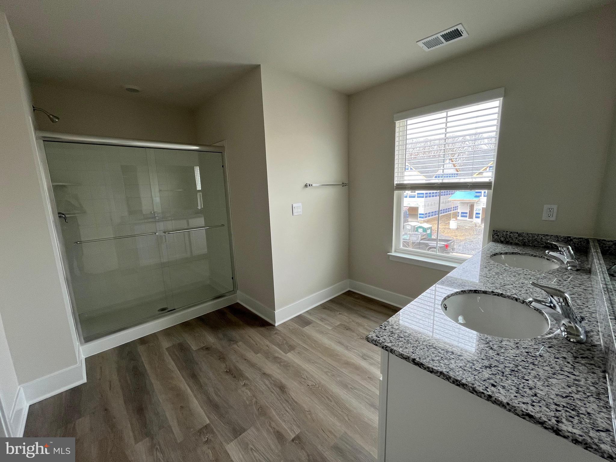 117 Manasquan Way Winchester, VA 22602 - Photo 9 of 34 a bathroom with a granite countertop sink a mirror and shower