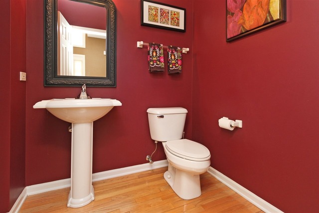 1561 Southgate Road Bartlett, IL 60103 - Photo 13 of 25 a bathroom with a toilet sink and mirror
