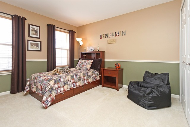 1561 Southgate Road Bartlett, IL 60103 - Photo 21 of 25 a large bedroom with a bed and window