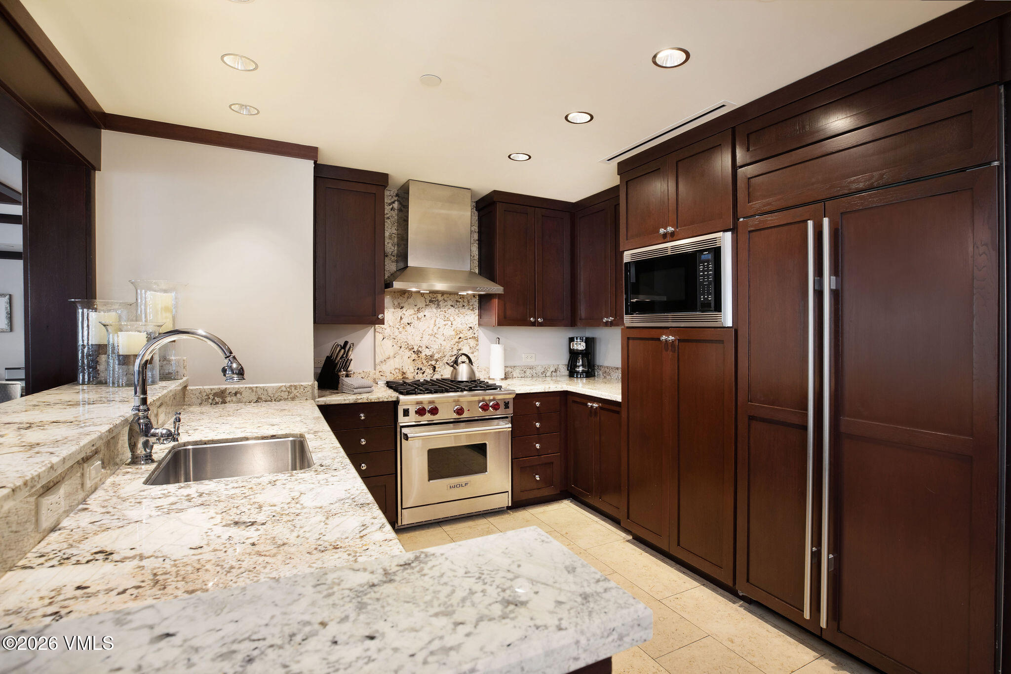 1 Vail Road, Unit 5102J Vail, CO 81657 - Photo 5 of 26 a kitchen with stainless steel appliances granite countertop a sink stove and refrigerator
