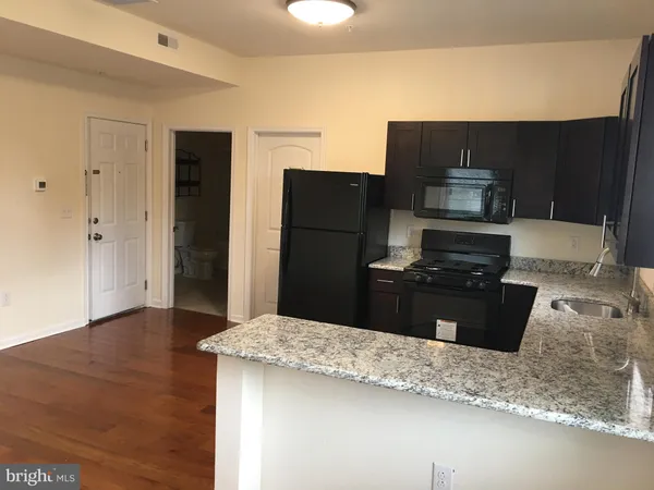 a kitchen with a refrigerator and a stove