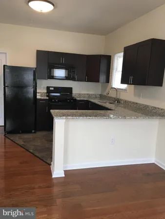 a kitchen with stainless steel appliances granite countertop a stove a microwave and a refrigerator