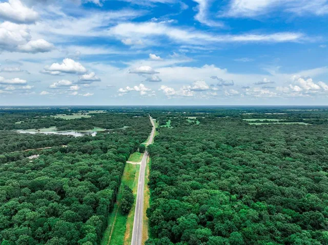 a view of a green field in the middle of a yard