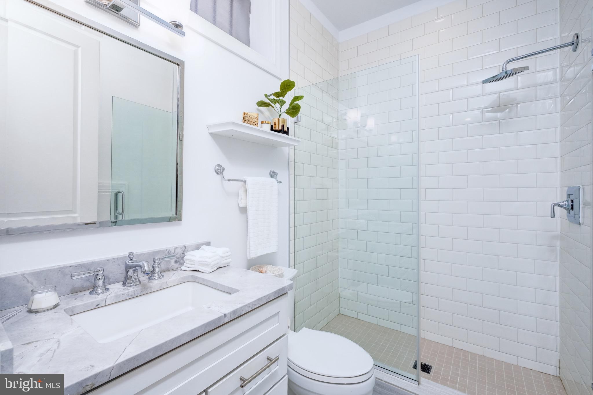 1929 19th Street Northwest, Unit 1 Washington, DC 20009 - Photo 20 of 21 Modern bath w/ recessed mirror & a walk-in shower