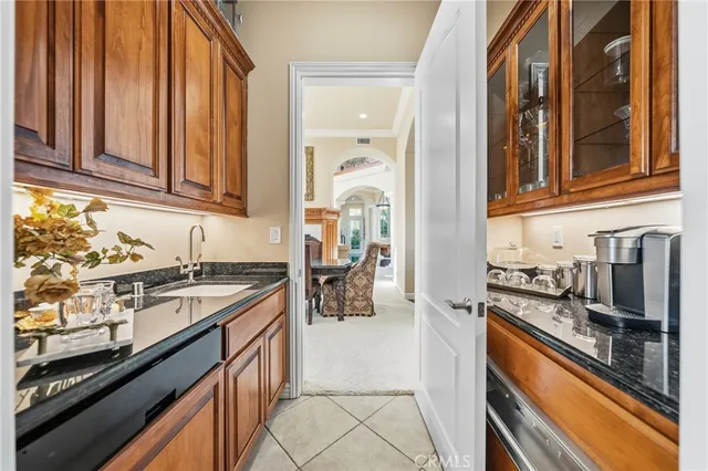 a bathroom with a granite countertop sink a mirror and shower