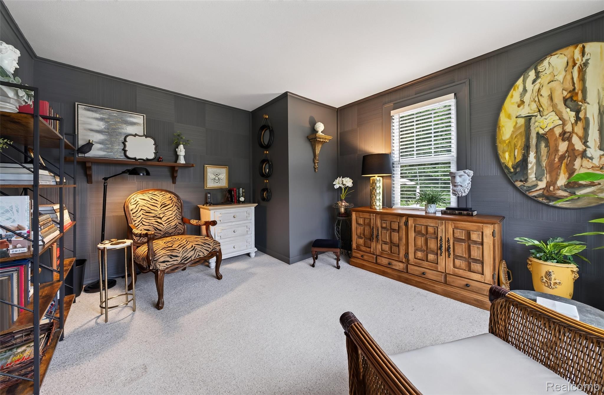 3841 Covert Road Waterford, MI 48328 - Photo 27 of 87 Sophisticated home office featuring dark gray walls, built-in shelving with display niches, wood-finish cabinetry with decorative hardware, carpet flooring, and large window with plantation shutters providing natural light and views of landscaping