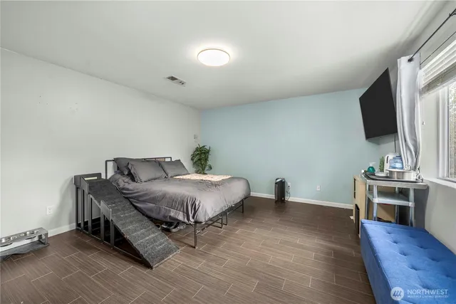 a bathroom with a granite countertop sink a toilet and shower