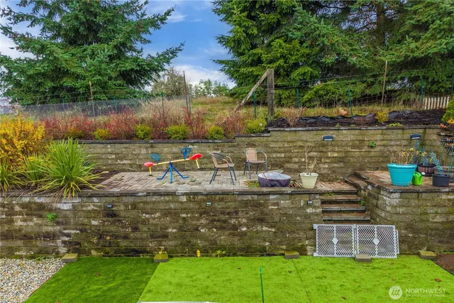 a view of garden with wooden fence