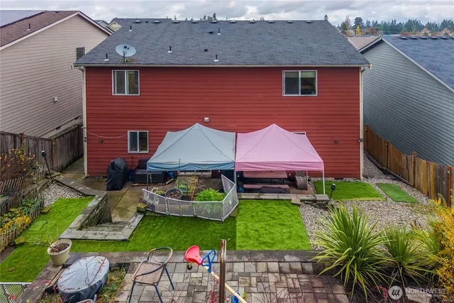an aerial view of a house with a yard