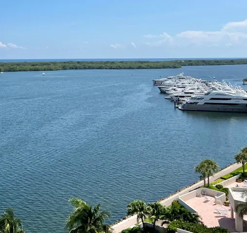 a view of a dining room with furniture large windows and wooden floor