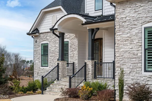 a kitchen with stainless steel appliances kitchen island granite countertop a sink a stove and a wooden floor