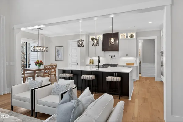 a large kitchen with stainless steel appliances kitchen island granite countertop a sink a stove and a wooden floor