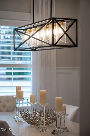 a living room with furniture a table and a large window