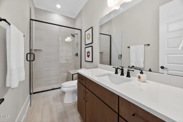 a living room with furniture kitchen view and a large window