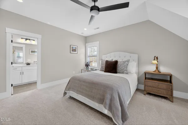 a view of a white house with a yard and sitting space