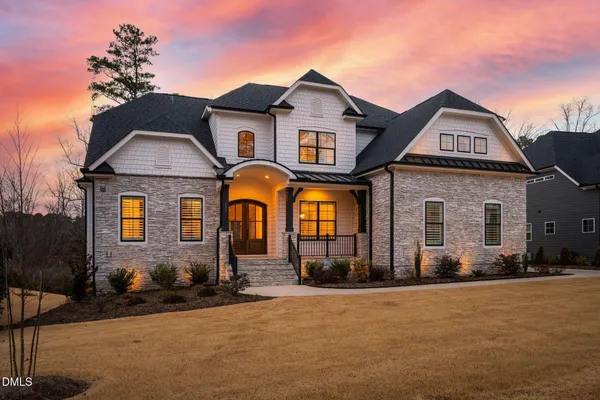 a view of staircase with lots of frames on wall and windows