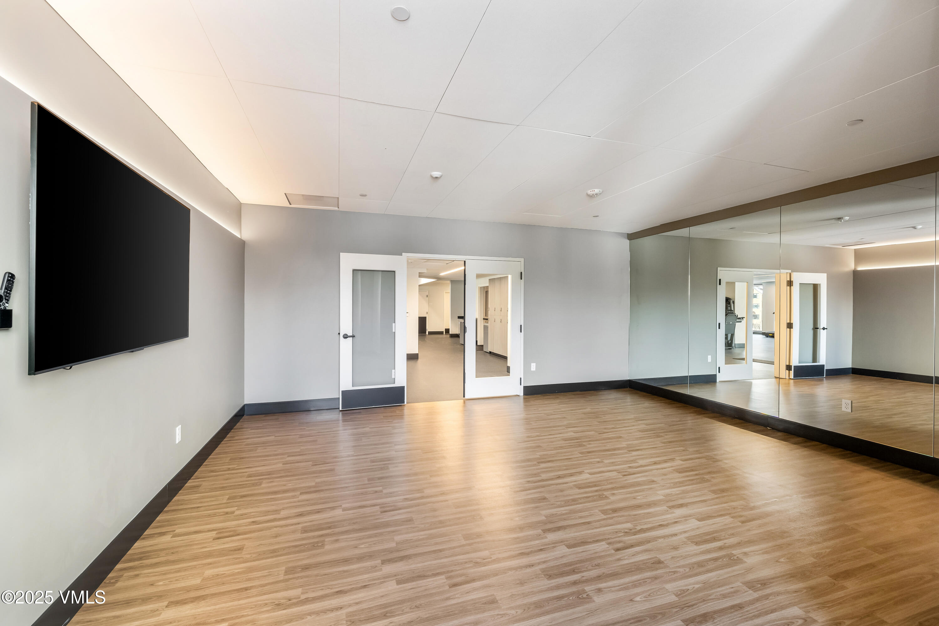 38460 Highway 6, Unit 310 Avon, CO 81620 - Photo 27 of 32 a view of an empty room with wooden floor and a window