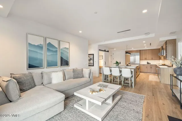 a spacious bedroom with a bed and a painting on the wall