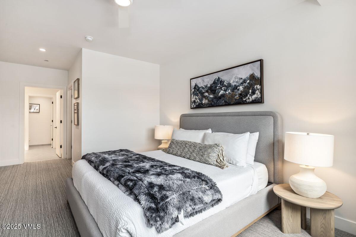 38460 Highway 6, Unit 310 Avon, CO 81620 - Photo 9 of 32 a spacious bedroom with a bed and a painting on the wall