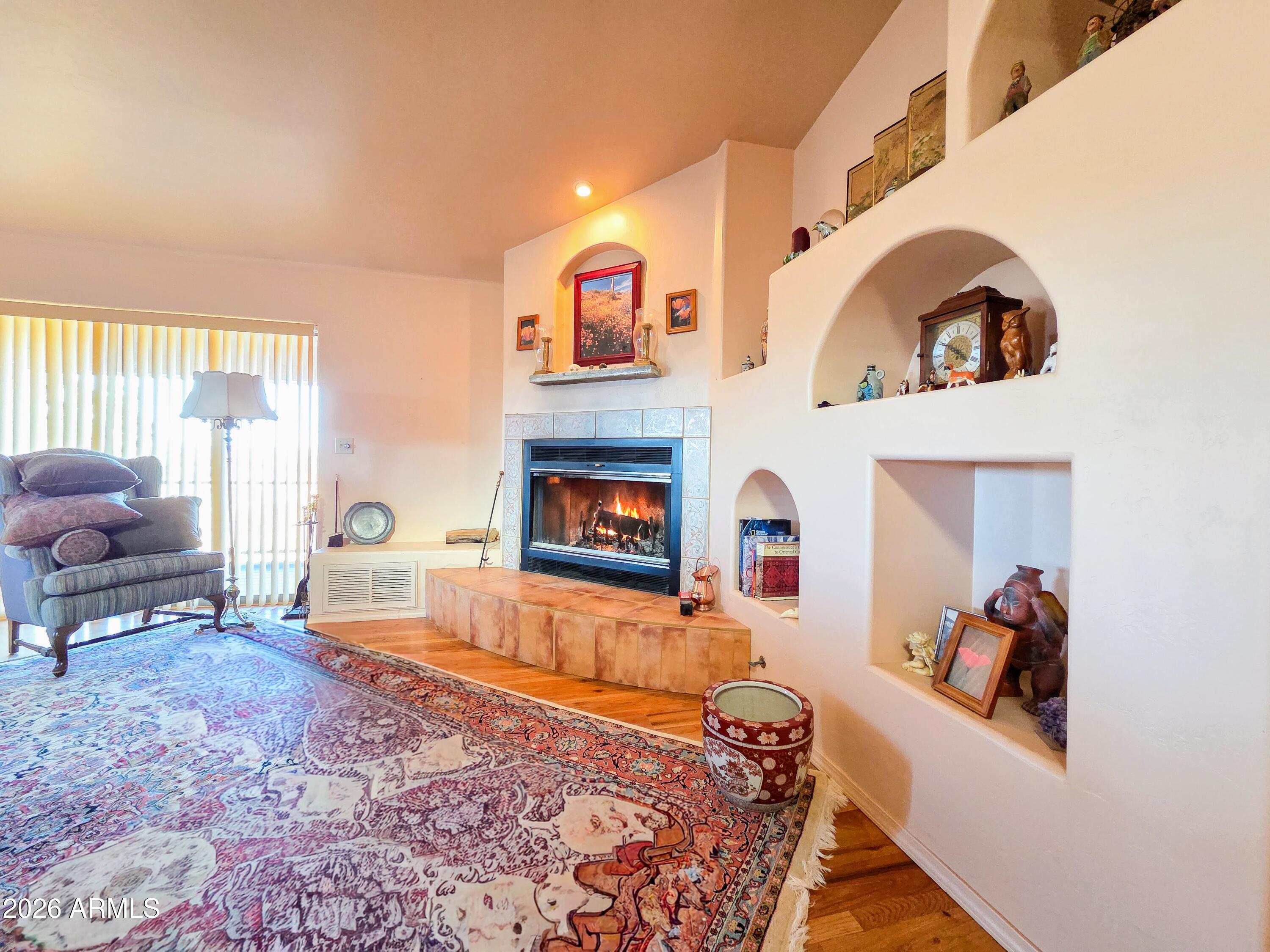 14350 East Meadow Ranch Place Dewey, AZ 86327 - Photo 12 of 54 a living room with furniture and a fireplace