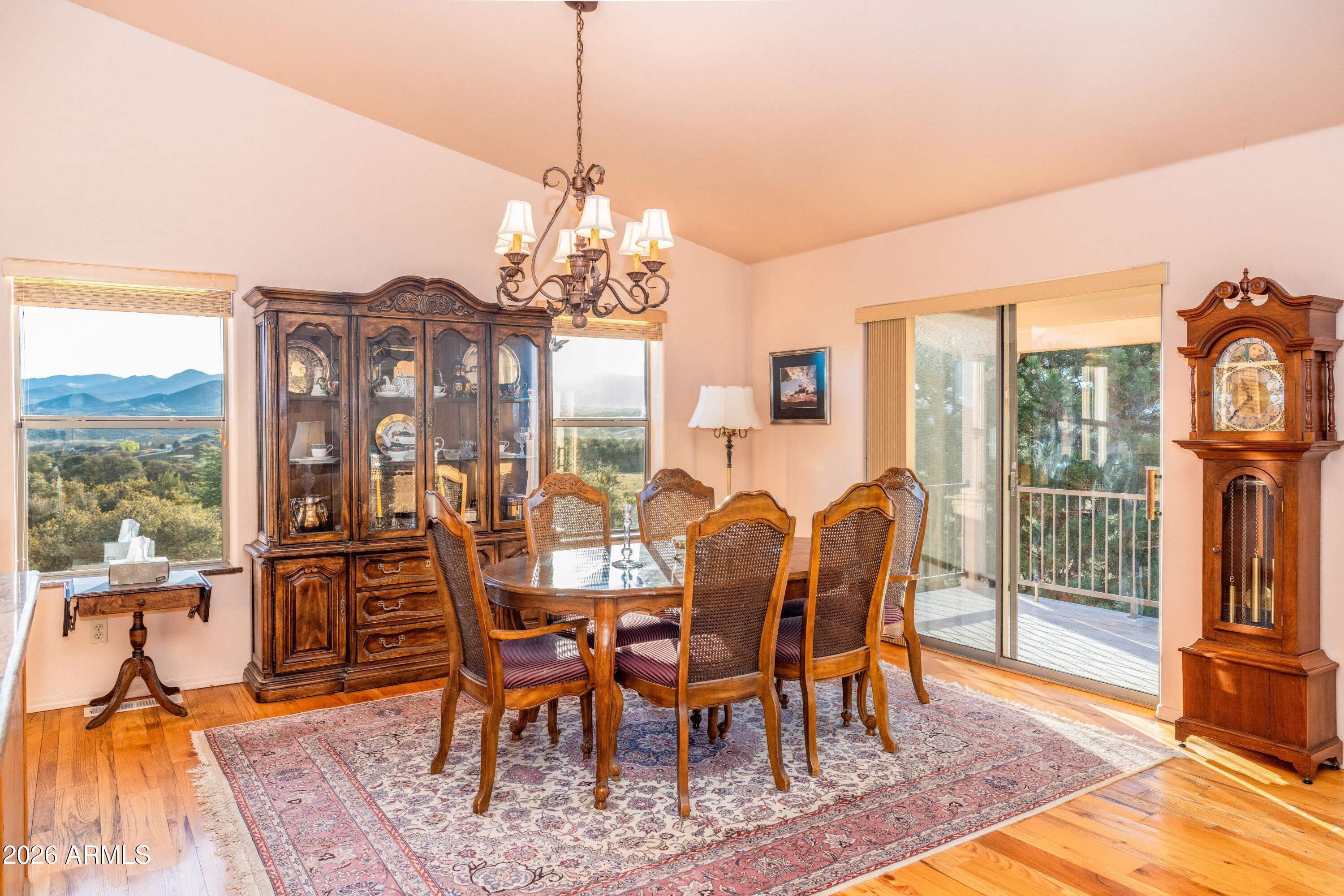 14350 East Meadow Ranch Place Dewey, AZ 86327 - Photo 14 of 54 a view of a dining room with furniture wooden floor and chandelier
