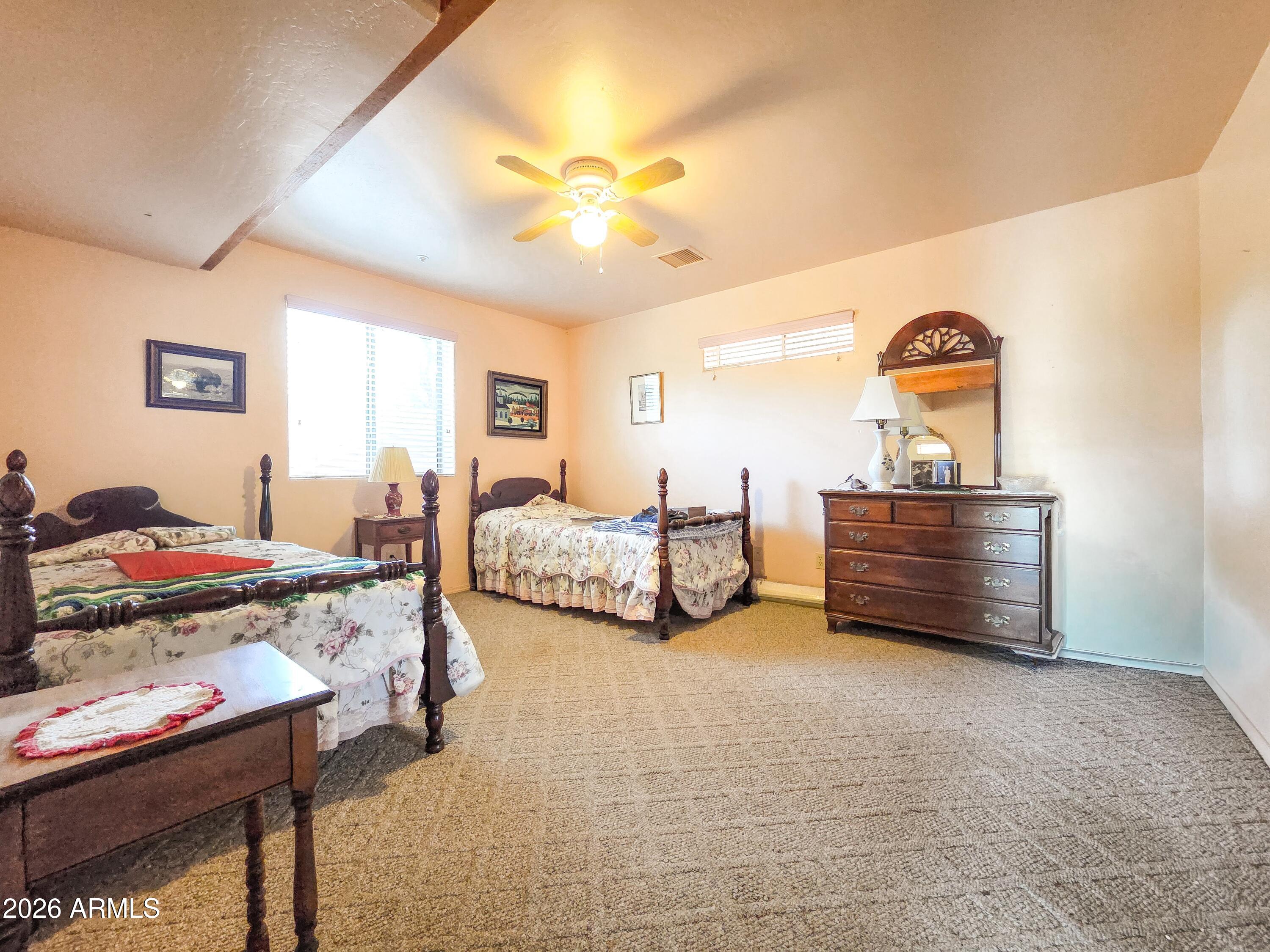 14350 East Meadow Ranch Place Dewey, AZ 86327 - Photo 35 of 54 a bedroom with furniture and a chandelier