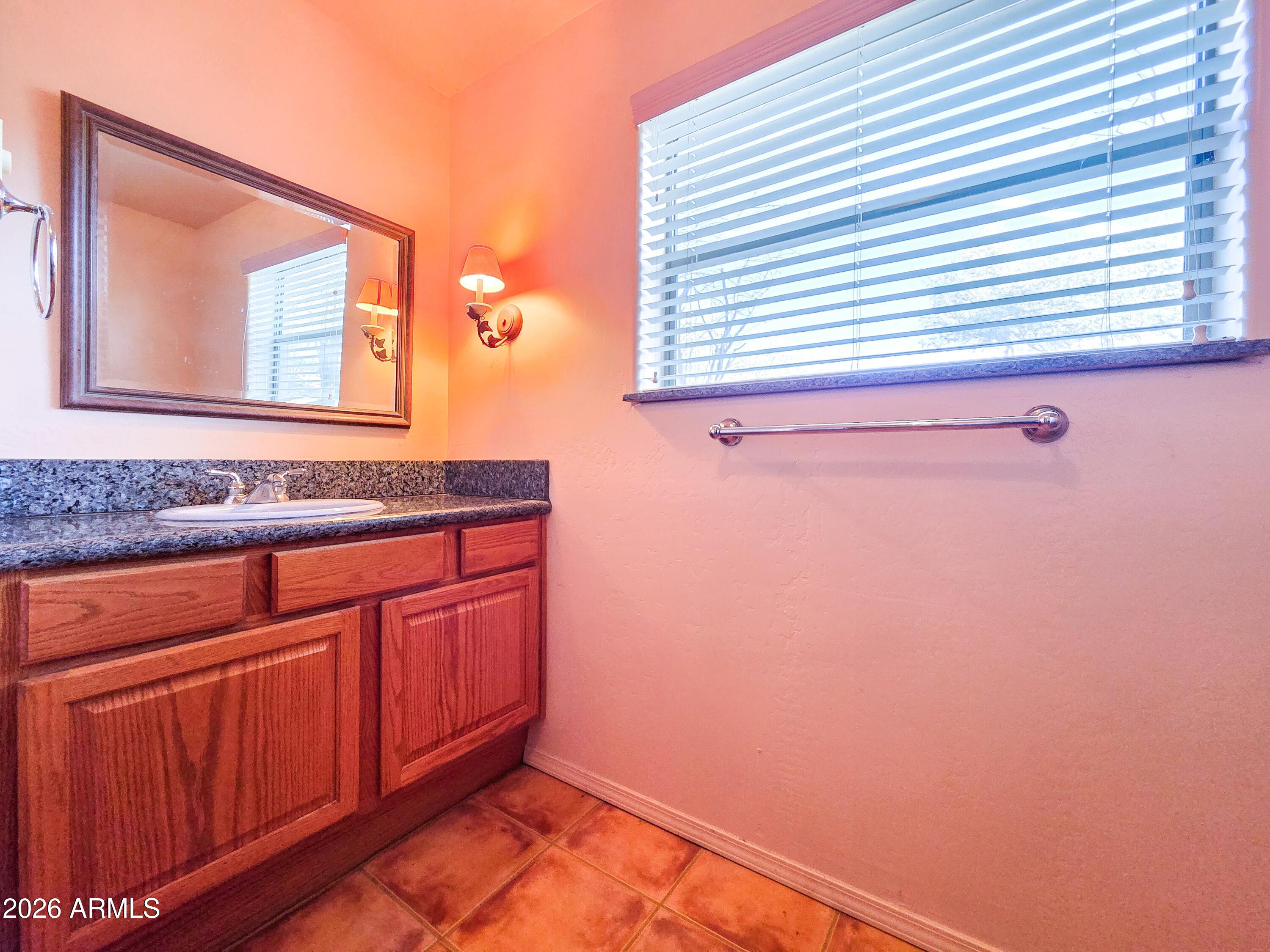 14350 East Meadow Ranch Place Dewey, AZ 86327 - Photo 36 of 54 a bathroom with a sink and a mirror