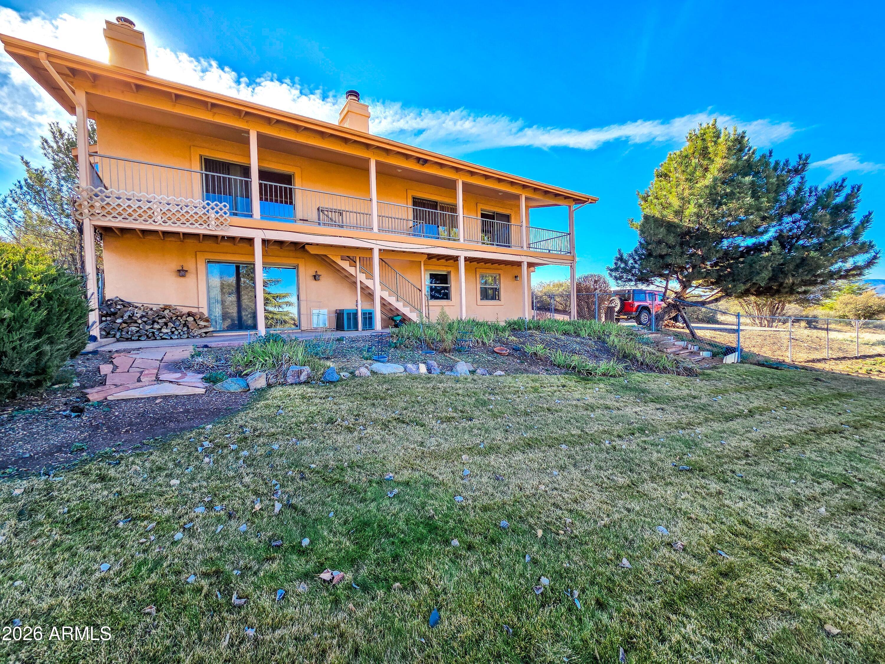 14350 East Meadow Ranch Place Dewey, AZ 86327 - Photo 5 of 54 a front view of a house with a yard