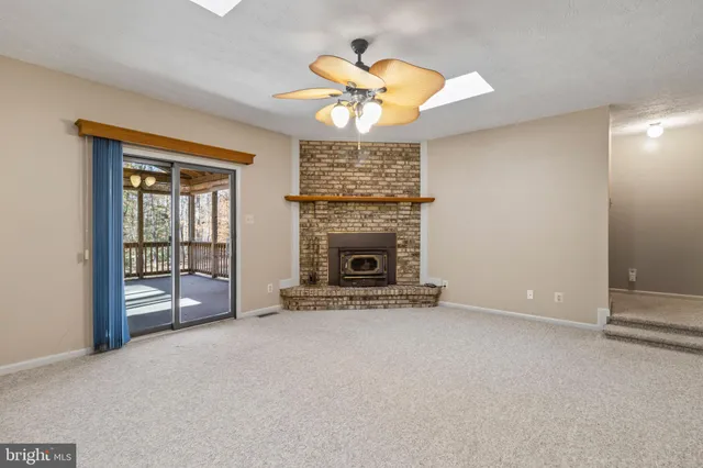 an empty room with a fireplace and fan