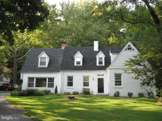 1010 Ashton Road Ashton, MD 20861 - Photo 1 of 12 a front view of a house with a garden