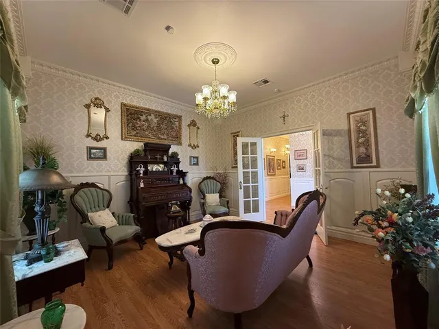 a living room with furniture and a chandelier