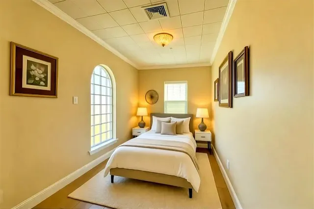 a bedroom with a bed and a window