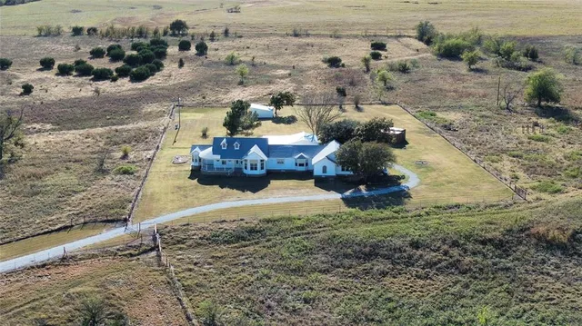 an aerial view of a house with outdoor space