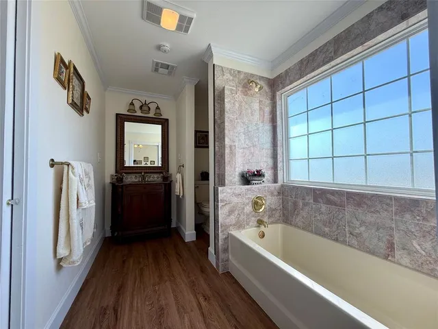 a bathroom with a bathtub a toilet and a shower