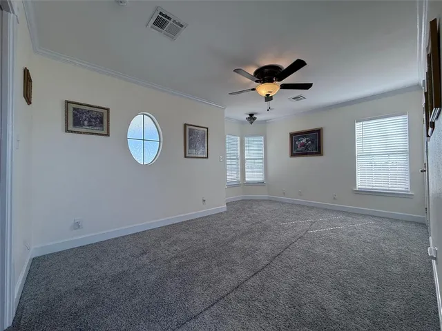 a view of a livingroom with a ceiling fan and window