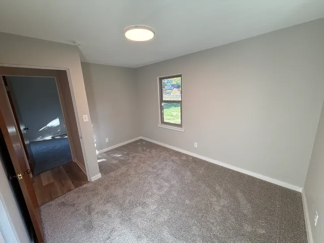 an empty room with a mirror