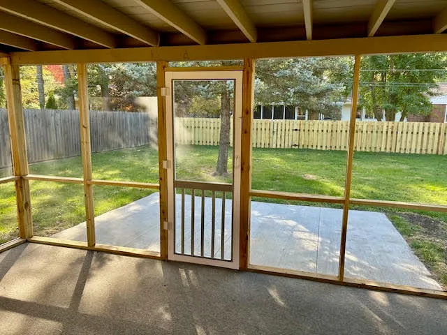 a backyard of a house with table and chairs