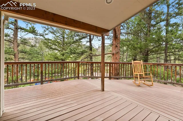 a view of a balcony with wooden floor and fence