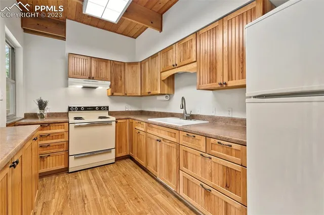 a kitchen with a stove top oven sink and cabinets