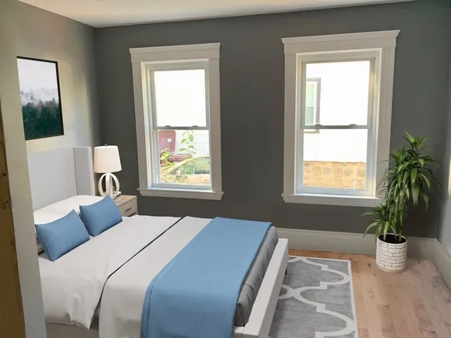 a bedroom with a bed and a window