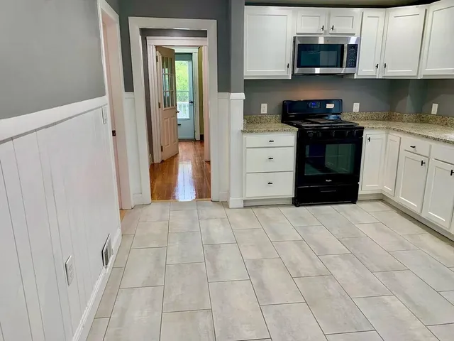a kitchen with stainless steel appliances granite countertop a stove and a refrigerator