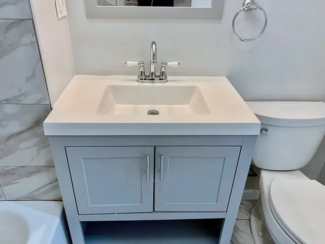 a bathroom with a sink toilet and vanity