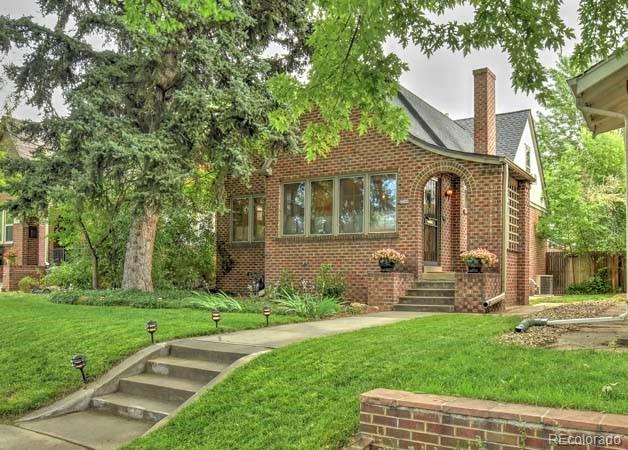 2536 Glencoe Street Denver, CO 80207 - Photo 1 of 26 a front view of a house with garden