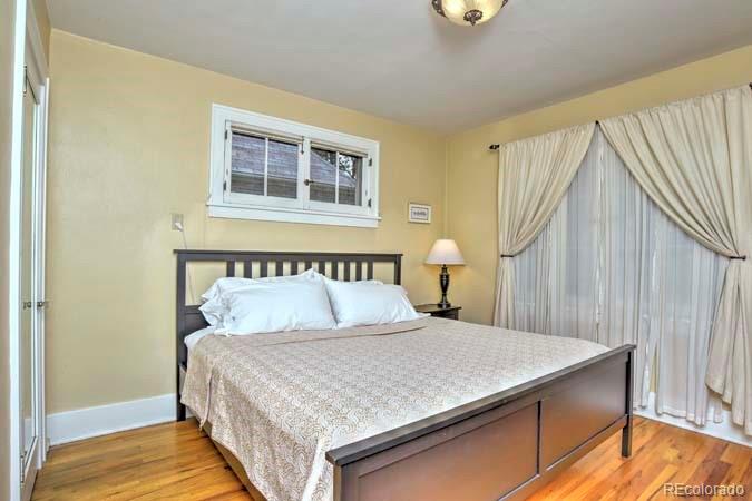 2536 Glencoe Street Denver, CO 80207 - Photo 12 of 26 a bedroom with a bed and a window