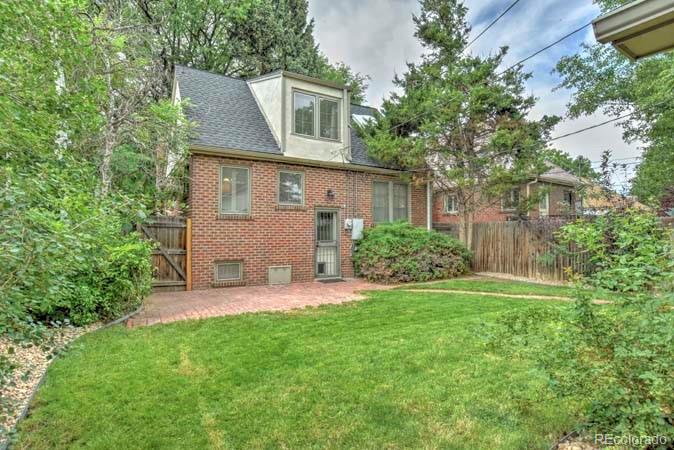 2536 Glencoe Street Denver, CO 80207 - Photo 16 of 26 a front view of a house with a yard and trees