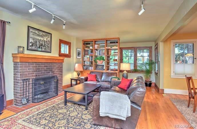 2536 Glencoe Street Denver, CO 80207 - Photo 2 of 26 a living room with furniture and a fireplace