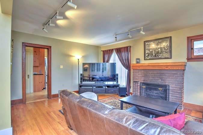 2536 Glencoe Street Denver, CO 80207 - Photo 3 of 26 a living room with furniture and a fireplace